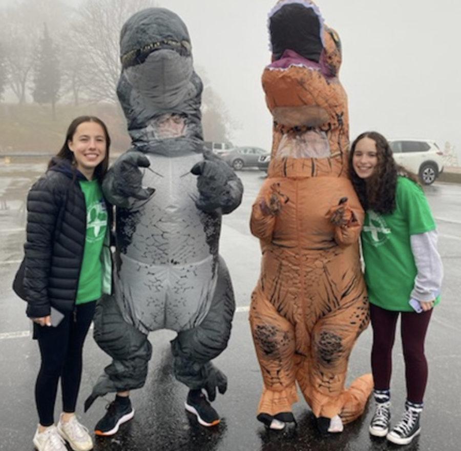Juniors Dina Sokolovskya and Mara Wolff stand next to Ms. Thompson and her son in blow-up dinosaur costumes