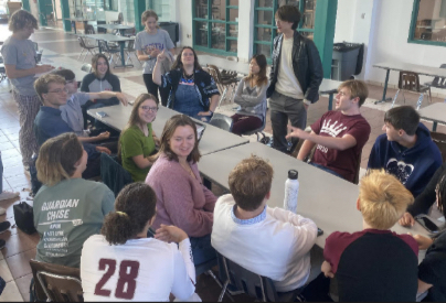 The club meeting in the commons during
homeroom, directed by President Aiden
Rodgers.
