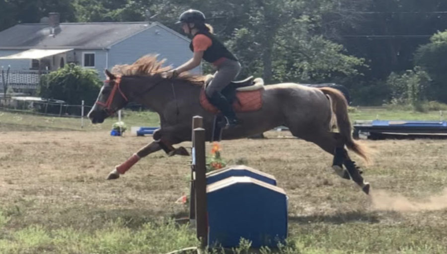 Freshman Olivia Hatt rides her horse Corduroy.