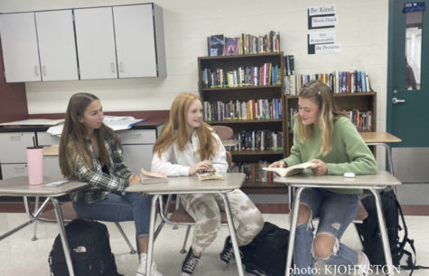 Club members Bella Chambers (left), Jillian Arnold (middle), and Kylee Johnston (right) discuss poetry during club meeting.