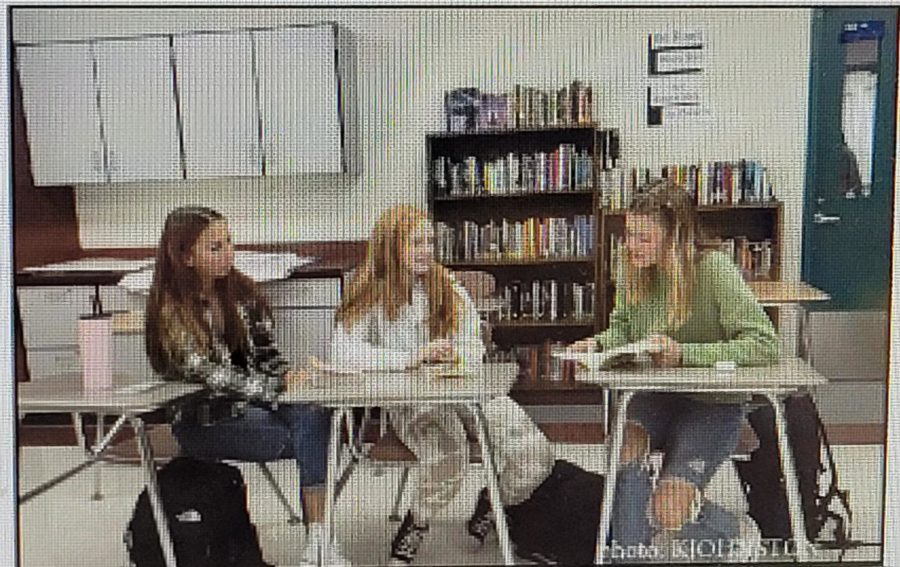 Club members Bella Chambers (left), Jillian
Arnold (middle), and Kylee Johnston (right)
discuss poetry during club meeting.
