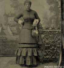 Studio portrait in front of painted
backdrop tintype