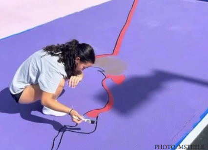 Senior Melina Steele paints an album cover on her spot.