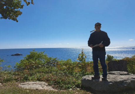 David Brule in front of a stunning backdrop of sea and sky